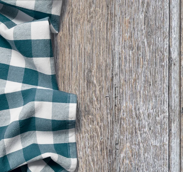 Picnic cloth over old wooden table grunge background