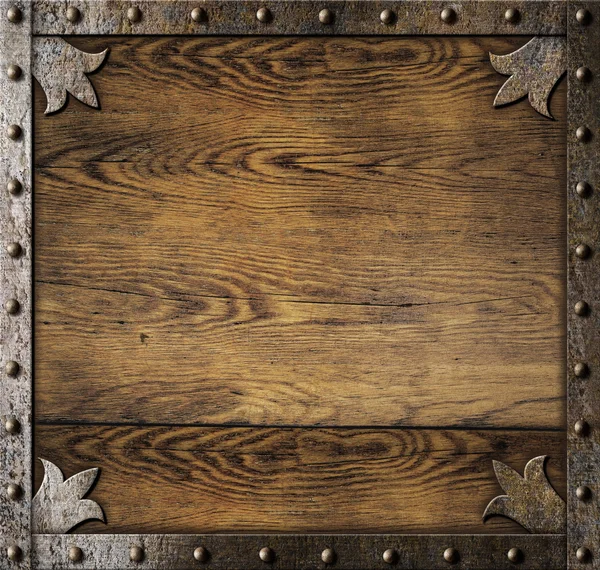 Medieval metal frame over old wooden background