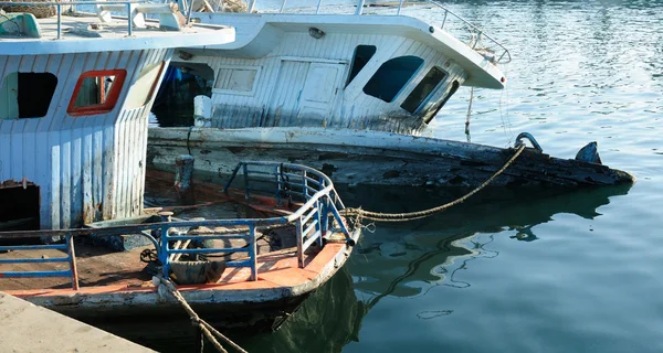 Broken sunken pleasure boat in the water, used toning of the photo