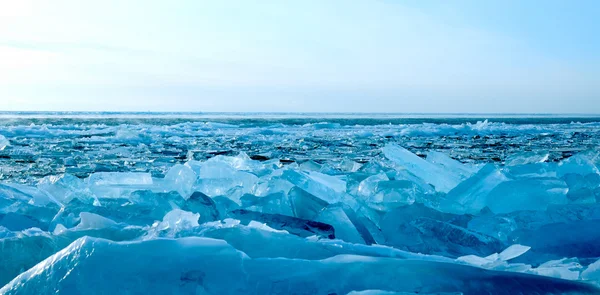 Winter. Ice on the surface of Lake Baikal. Cracks in the ice surface. Ice storm. Used deep blue toning of the photo.