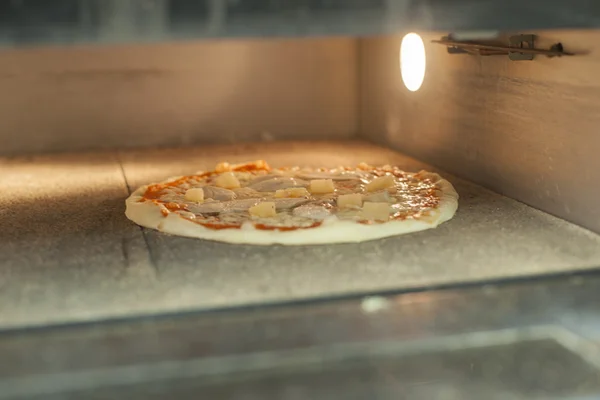 Pizza baking in the oven