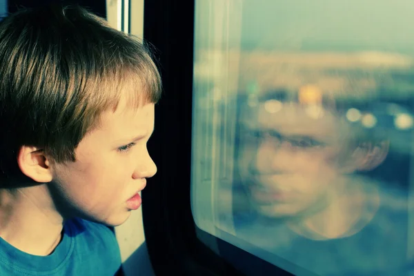 Boy near window