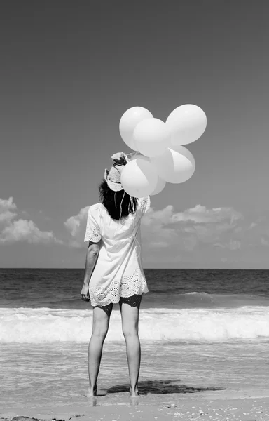 Woman with white balloons