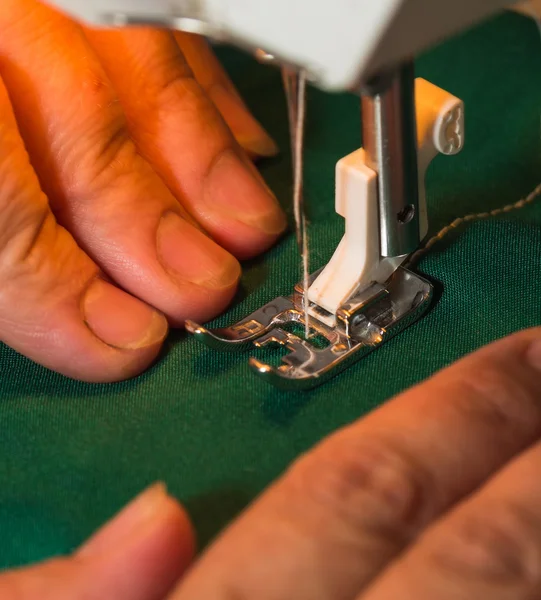 Hands and sewing machine