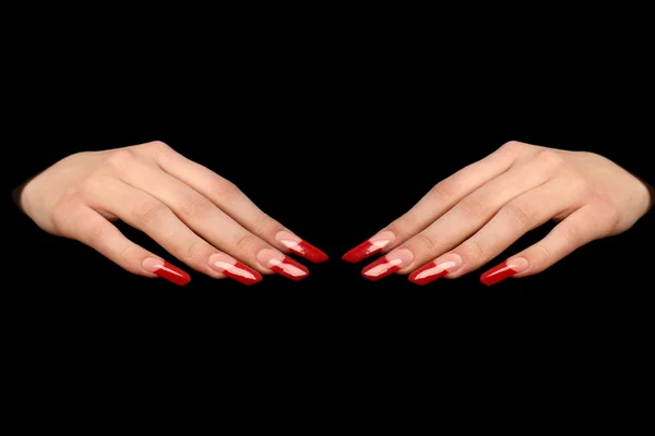 Pretty woman hand with perfect painted nails isolated on black background