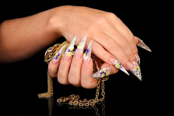 Pretty woman hand with perfect painted nails isolated on black background