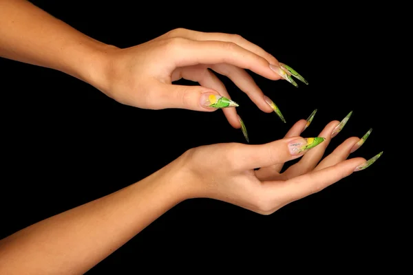 Pretty woman hand with perfect painted nails isolated on black background