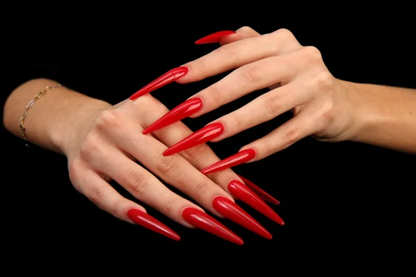 Pretty woman hand with perfect painted nails isolated on black background
