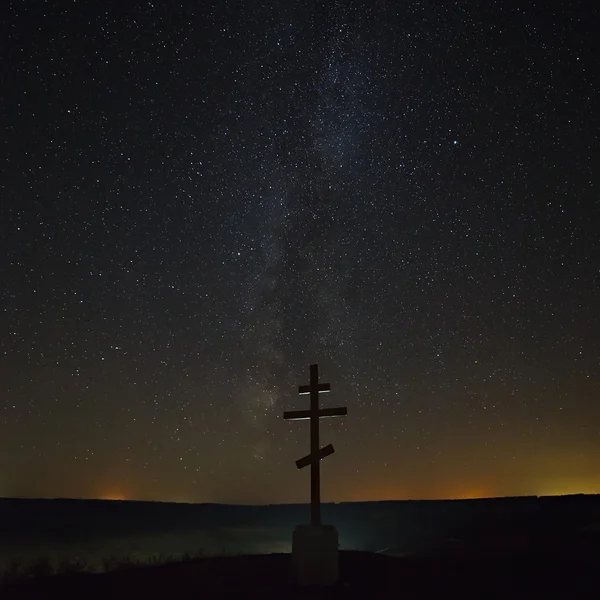 The cross on the background of the Milky Way in the night sky.