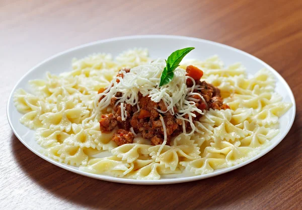 Pasta with meat cheese and garnish with mint.