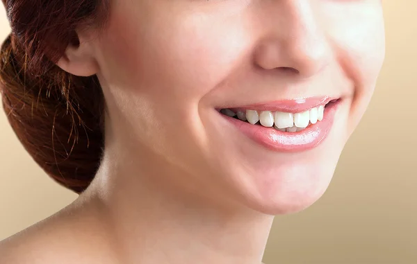 Beautiful Woman healthy smile close up. Closeup Ceramic Braces o
