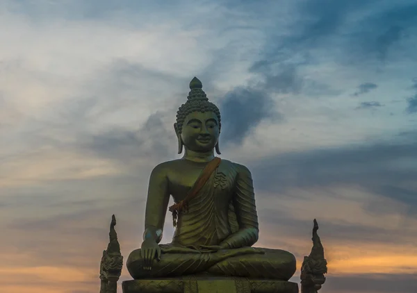 Bottom view of unfinished Big Buddha Statue at Wat Phrathong over beautiful sunset sky background