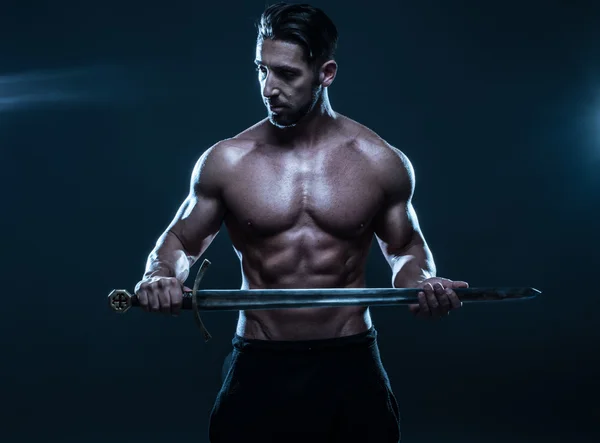 Gorgeous Shirtless Muscled Man Holding a Sword