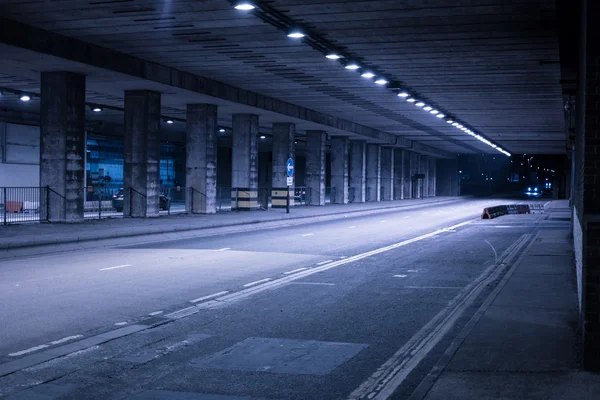 Covered Street Illuminated at Night