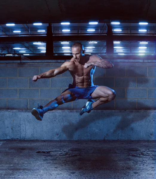 Athletic Man in Fighting Pose Inside a Building
