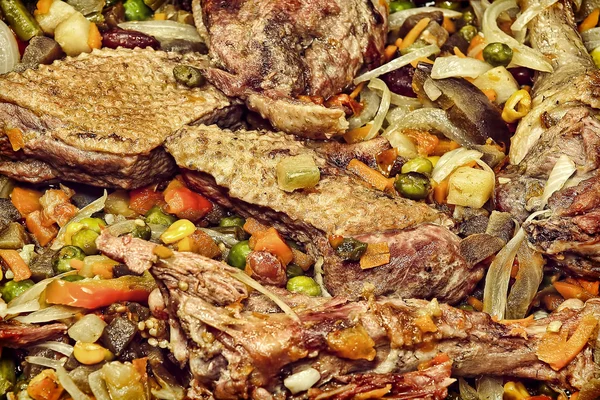 Appetizing roasted meat with vegetables taken closeup.