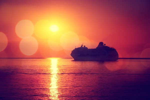 Silhouette of Cruise Ship at Sea Sunset Background