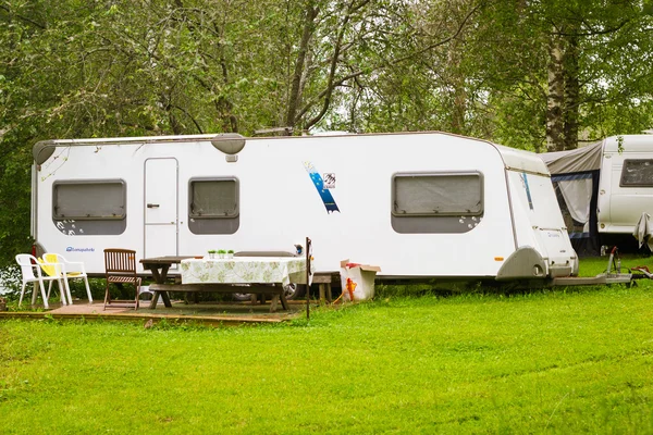 Camping van on a green meadow. Palvaanjarven Campsite, Lappeenra