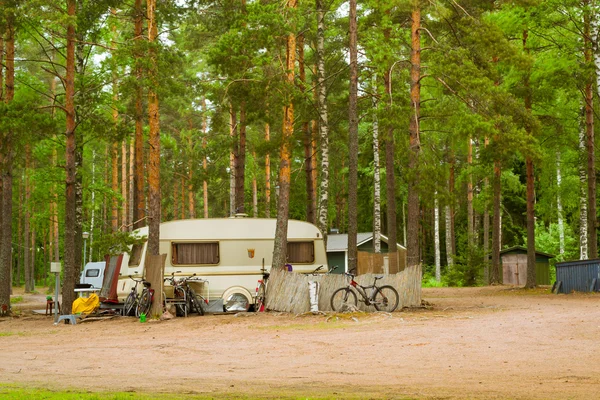 Camping vans and bikes in wooded campsite. Hamina, Finland, Suomi