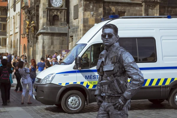 Meme-artist in the form of futuristic police posing on old Town Square