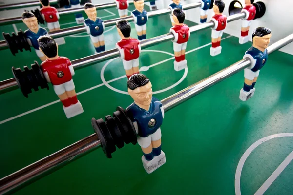 Foosball Figures . Miniature figures of  players fixed on rods .