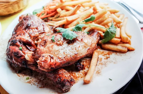 Chicken with sauce and French fries