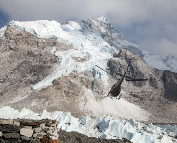 Helicopper in Everest base camp and mount Nuptse, Nepal