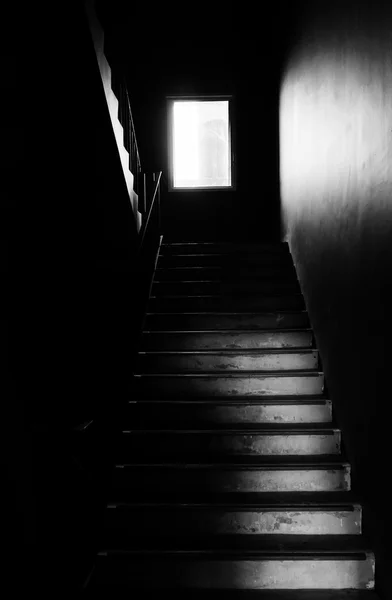 Dark fire exit stair with light from window background texture