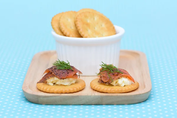Salmon cream cheese biscuit on blue vintage background