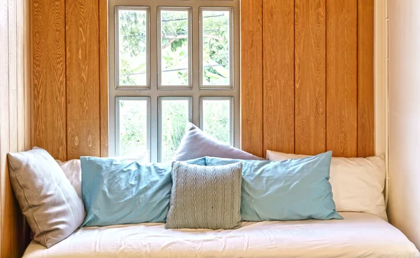 Sofa bed in wooden cottage style room interior