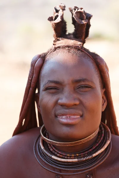 Himba woman with ornaments on the neck in the village