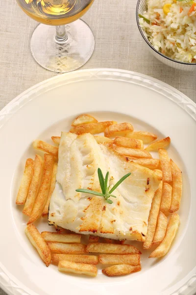 Baked fish and chips on elegant plate