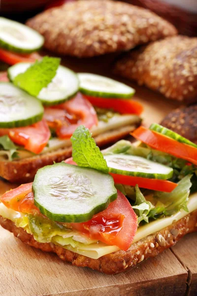 Vegetarian sandwich with pesto on wooden background