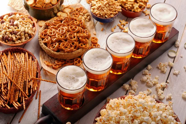 Football fan set with beer and snacks on wooden background