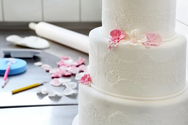 Confectioner decorates wedding cake