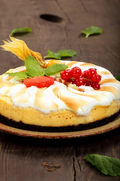 Pudding cake with fruit on a wooden background