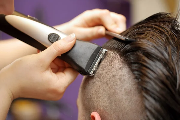 Barber shaving hair by electric trimmer