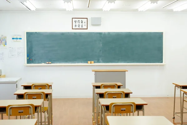 School classroom with school desks and blackboard