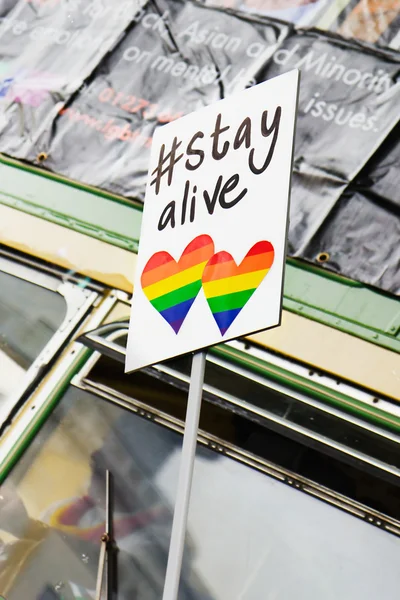 Stayalive sign with rainbow hearts at a gay pride parade