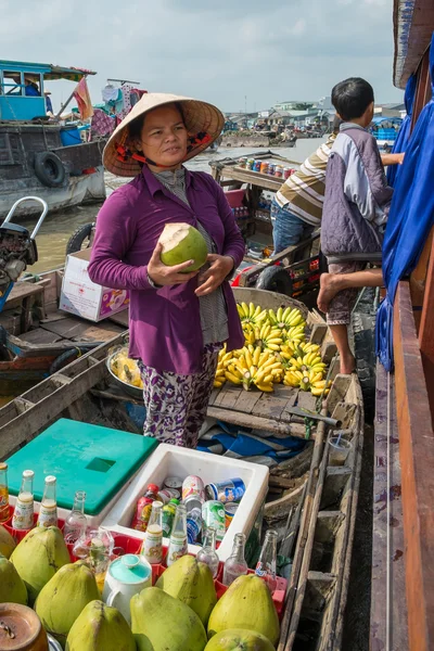 Women selling goods from a boat on the Mekong River, Vietnam
