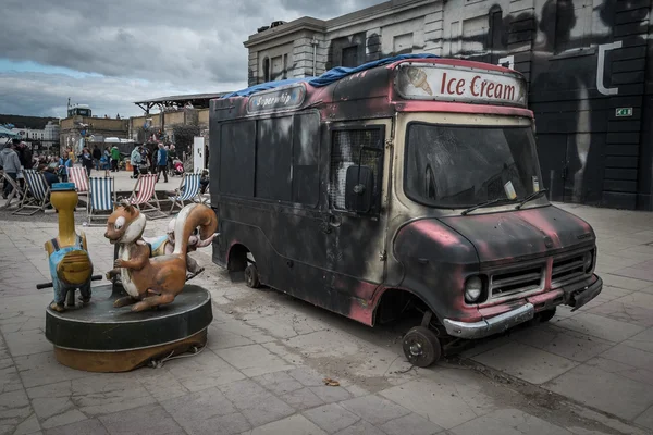 Burnt out ice cream van at Banksy\'s Dismaland Bemusement Park.