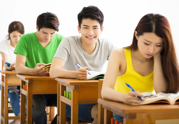 Young college student group sitting in a classroom