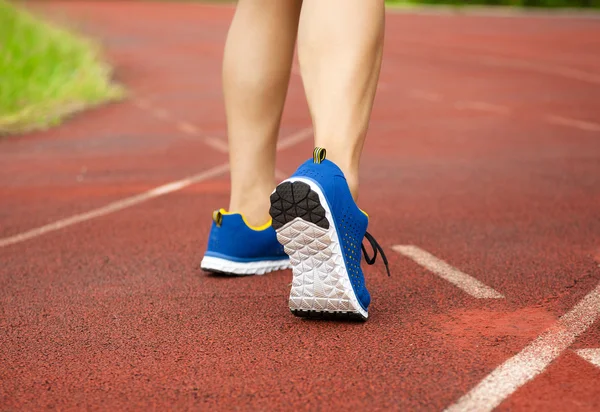 Runner feet running on track. workout wellness concept