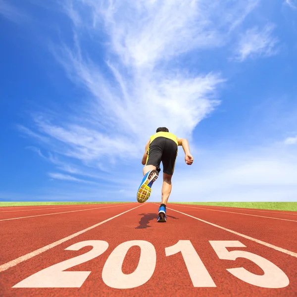 Happy new year 2015. young man running on tr