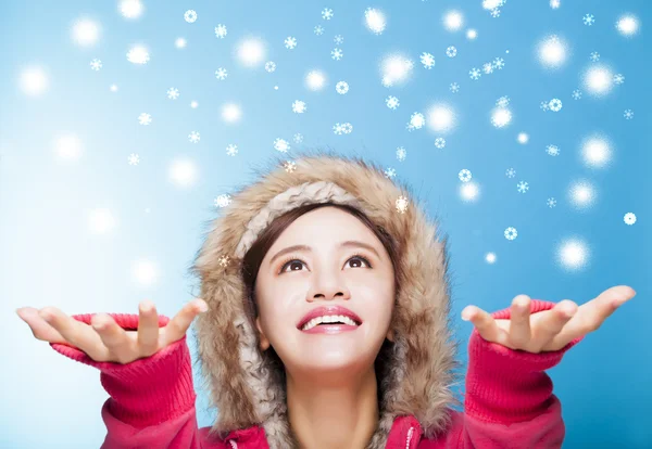Happy young woman watching snow