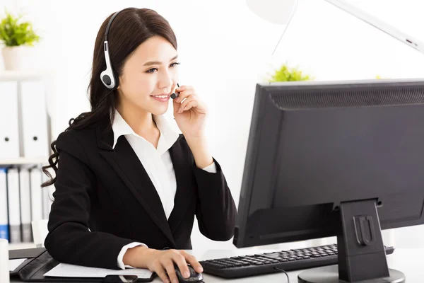 Young beautiful  business woman with headset in office