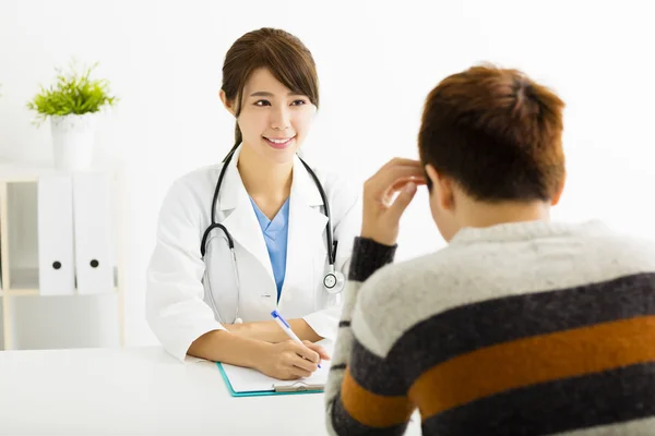 Female doctor talking with patient in office