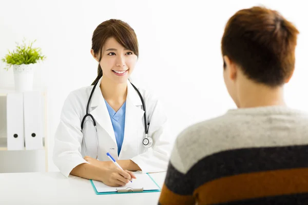 Female doctor talking with patient in office