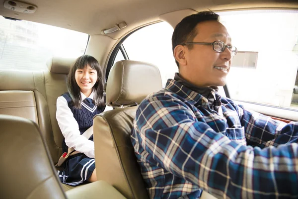 Father driving to school with teen daughter