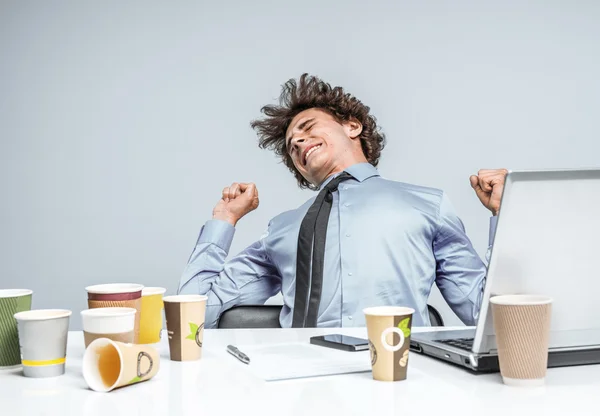 Student stretches from fatigue, kneads the back at the workplace.